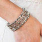 Paparazzi Thematic Twinkle - Silver Bracelets dotted with layers of smoky hematite rhinestones, flared and textured silver bars crisscross and merge into shiny silver frames. Threaded along stretchy bands, the smoldering frames create an intensely swanky fashion around the wrist.  Sold as one individual bracelet.  Magnificent Musings Fashion Fix February 2022