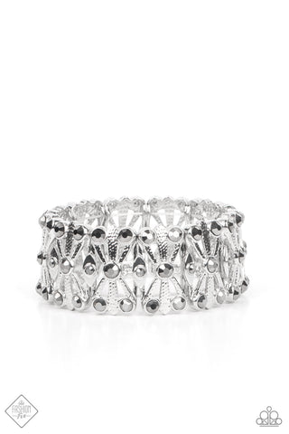 Paparazzi Thematic Twinkle - Silver Bracelets dotted with layers of smoky hematite rhinestones, flared and textured silver bars crisscross and merge into shiny silver frames. Threaded along stretchy bands, the smoldering frames create an intensely swanky fashion around the wrist.  Sold as one individual bracelet.  Magnificent Musings Fashion Fix February 2022