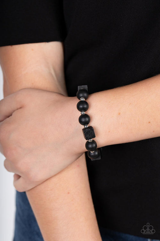 Paparazzi Accessories - Timber Trendsetter - Black Wood Bracelet infused with dainty silver beads, an earthy collection of round and cube black wooden beads are threaded along a stretchy band around the wrist for a natural look.  Sold as one individual bracelet.