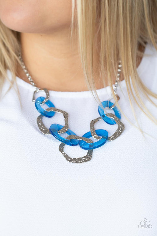 Urban Circus - Blue Acrylic Necklaces an asymmetrical assortment of neon blue acrylic rings and hammered silver hoops boldly interlock below the collar, creating an intense pop of color. Features an adjustable clasp closure.