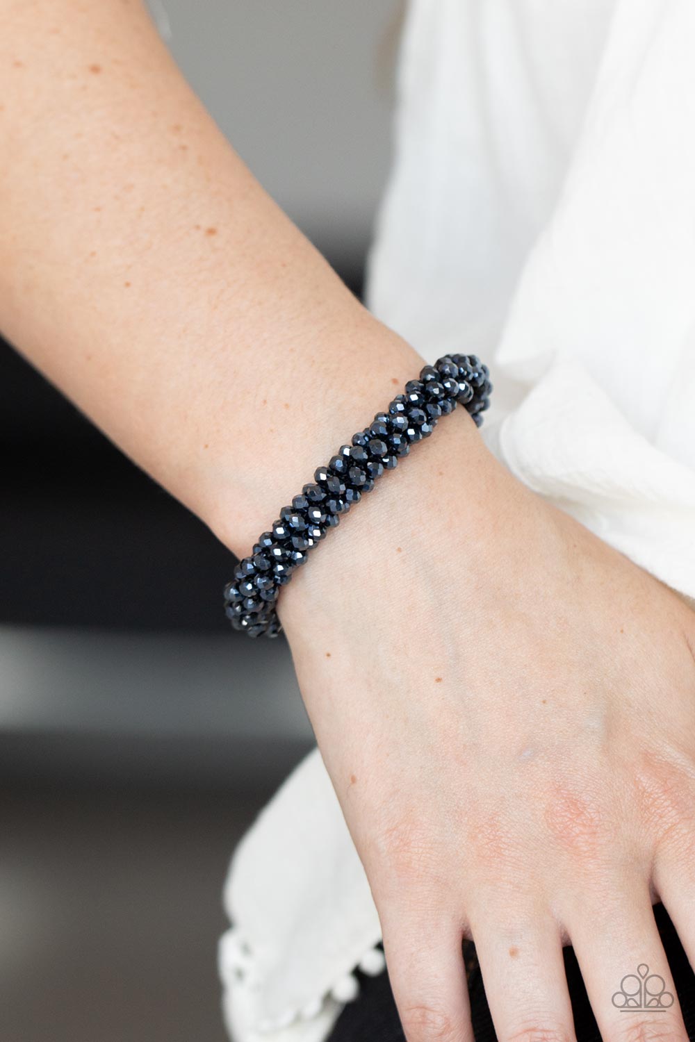 Wake Up and Sparkle - Blue Beaded Bracelets sparkling with dramatic brilliance, a collection of dainty faceted blue beads are threaded along a woven stretchy band creating a stunning statement around the wrist.  Sold as one individual bracelet.  Paparazzi Jewelry is lead and nickel free so it's perfect for sensitive skin too!
