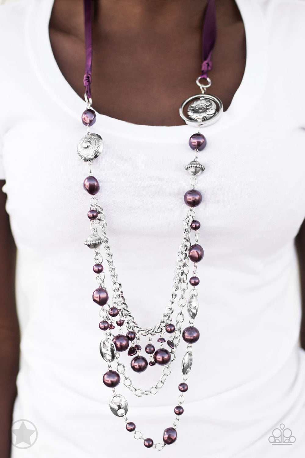 Paparazzi Accessories All the Trimmings - Purple Necklaces a silky purple ribbon replaces a traditional chain to create a timeless look. Pearly deep purple beads and funky silver pieces intermix with varying lengths of silver chains to give a fresh take on a Victorian-inspired piece.