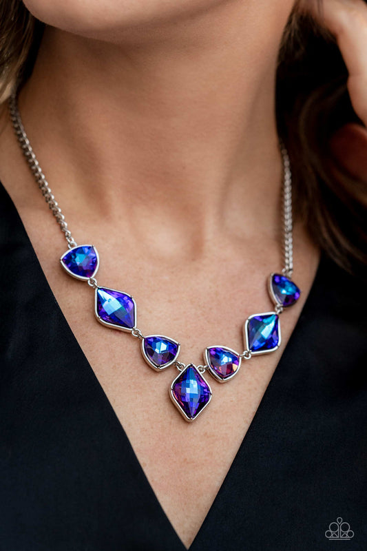 Set in silver frames, glittering geometric purple shapes with a UV shimmer delicately coalesce around the collar for a statement piece. Features an adjustable clasp closure. Due to its prismatic palette, color may vary.   Sold as one individual necklace. Includes one pair of matching earrings.